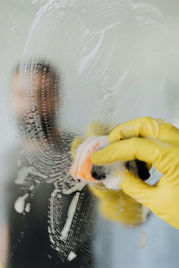 Professional janitorial cleaning team working in an office building, focusing on high-touch areas and using advanced cleaning equipment and eco-friendly products.